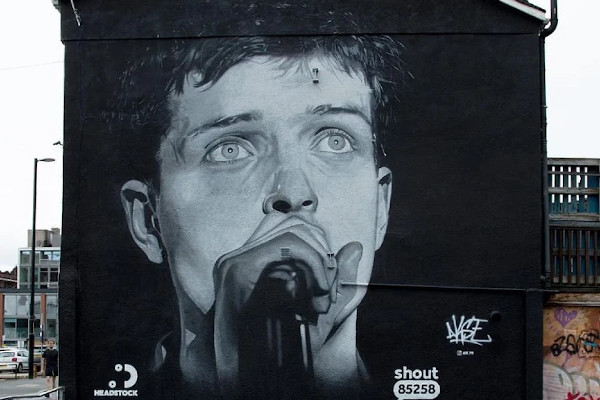 Ian Curtis mural in Manchester painted over for Aitch advertisement, Aitch apologizes